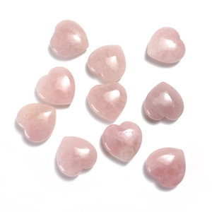 Close-up of ten heart-shaped polished rose quartz stones on a clean white background