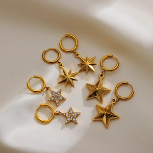 Detail of s925 silver gold-plated star earrings with crystal inlays on silk
