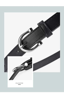 Macro detail of a minimalist black leather belt with a silver horseshoe metal buckle