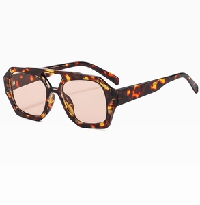 Detailed side view of tortoise frame sunglasses with pink lenses and double bridge design