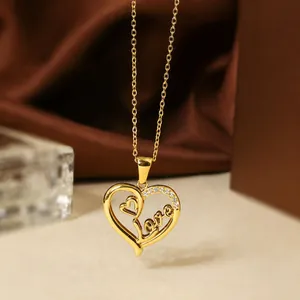Detail of gold titanium steel heart pendant with Love script and zircon stones