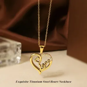 Detail of gold titanium steel heart pendant with Love script and zircon stones