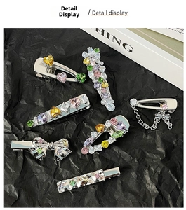 Detailed macro view of colorful zircon hair clips with heart shapes and metal chains