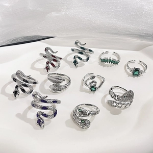 Silver snake rings set with colorful zircon stones in a vintage minimalist aesthetic