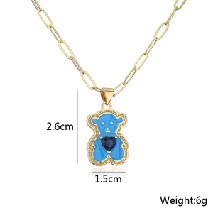 Detail of 18K gold plated heart bear pendant with blue enamel and zircon inlay on necklace