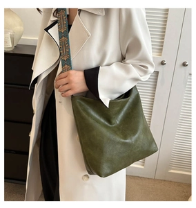 Detail of olive green PU hobo bag with ethnic style wide jacquard shoulder strap