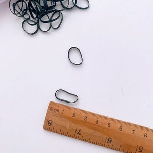 Close-up of black high-elastic hair ties showing 1.5-2cm diameter size measurement