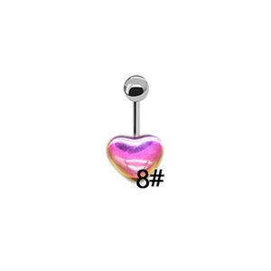 Macro detail of silver navel piercing with iridescent pink heart pendant and crystal stud
