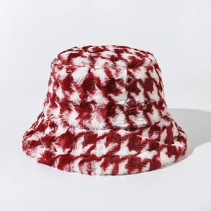Close-up of soft red and white houndstooth faux fur texture on a warm bucket hat