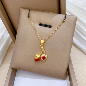 Elegant gold cherry necklace featuring red rhinestones on a minimalist dainty chain