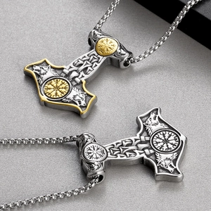Close-up of Mjolnir Thor Hammer pendants with wolf head reliefs and Viking runes