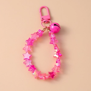 Detailed view of pink star beads and matching bell on a cute keychain wristlet
