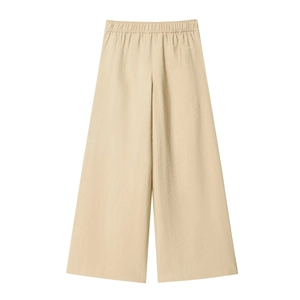 Detail of apricot wide-leg pants showing elastic waistband and textured fabric weave