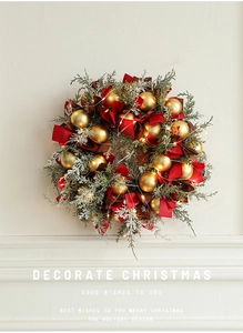 Detailed close-up of a 40cm Christmas wreath with red ribbons, gold baubles and LED lights