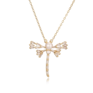 Gold dragonfly pendant necklace with pearl body and cubic zirconia wings on white background