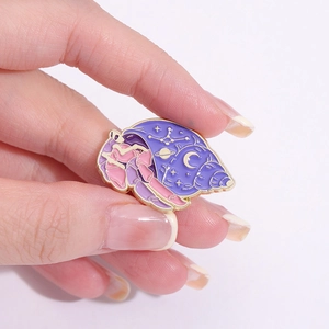 Cartoon ocean series enamel pin with purple seashell and starry sky pattern