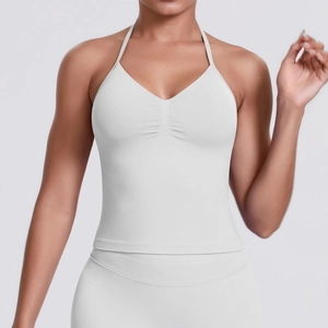 Detail of white halter neck sports bra showing ribbed texture and central pleat design