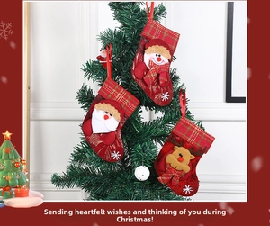 Close-up of 3D Santa, Snowman and Reindeer Christmas stockings hanging on a tree
