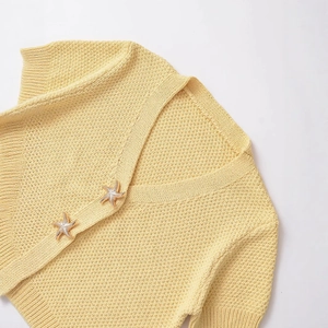 Cream chunky knit cardigan with gold starfish buttons and ribbed V-neckline detail