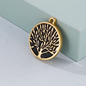 Gold stainless steel Tree of Life pendant with black enamel finish on a display box