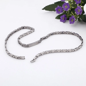 Detail of silver titanium steel magnetic health necklace with inset therapy stones