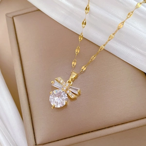 Macro shot of butterfly pendant necklace with cubic zirconia on white silk