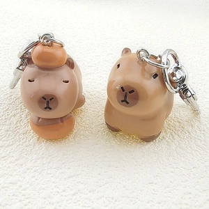 Cute Capybara resin keychain charms featuring a classic pose and orange on head design