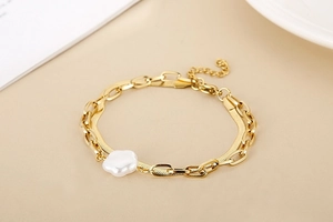 Detail of gold double-layer snake chain bracelet with white flower charm and adjustable clasp