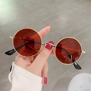Detail view of model E8030 vintage round sunglasses with gold frame and amber lenses