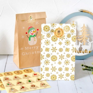 Christmas kraft gift bags with snowman and snowflake patterns including festive stickers