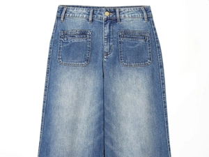 Detail view of high-waist wide-leg denim jeans with large front patch pockets in blue wash