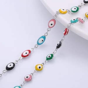 Colorful evil eye bracelet with oval enamel beads in vibrant hues and silver-tone chain link