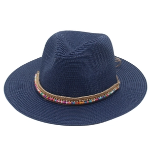Detail of navy blue straw Panama hat featuring colorful ethnic beads and rhinestone band