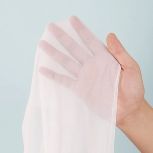 Detail of light pink sheer mesh fabric showing fine breathable texture and soft transparency