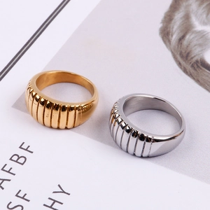 Macro detail of gold and silver croissant style rings with ribbed texture on magazine
