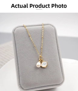Detail of freshwater pearl and shell flower pendant on a dainty gold beaded chain