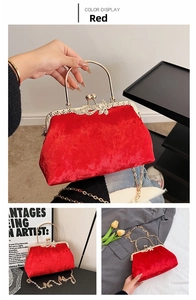 Macro view of red velvet evening shell bag with gold clasp and bow handle detail
