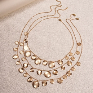 Three-layer gold layered necklace with geometric circular pendants and hammered finish