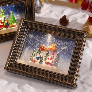 Detail of vintage gold embossed frame Christmas music box with snowy Santa scene