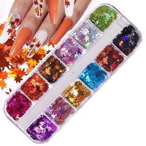 Detail of autumn maple leaf nail art sequins in a 12-grid storage box with laser colors