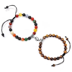 Detail of magnetic stone couple bracelets with seven chakra beads and tiger eye stones