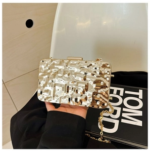 Metallic gold clutch bag with pleated texture and thin chain strap for evening events