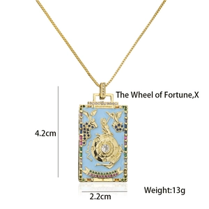 Detail view of 18K gold plated Wheel of Fortune tarot necklace with enamel and gems