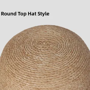 Close-up of the round crown and fine spiral weaving on a natural raffia straw hat