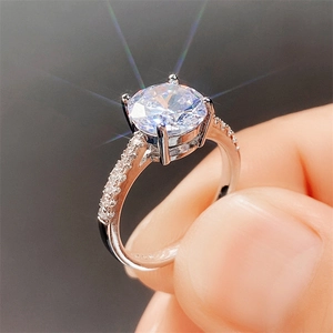 Macro detail of luxury four-prong round zircon engagement ring with silver finish