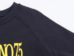 Detail of dark blue sweatshirt showing ribbed crew neck, raglan sleeve, and No.75 print