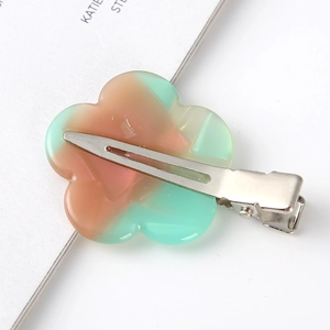 Detail shot of the pink-green gradient flower hair clip on a metal duckbill base