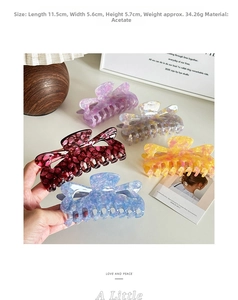 Detail view of large acetate claw clips in five colors with natural cloud textures
