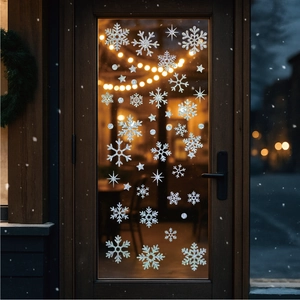 Silver glitter snowflake stickers applied to a glass door for festive winter decor