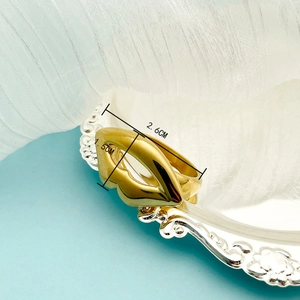 Artistic hollow kiss lip ring in 14K gold plated stainless steel on decorative tray